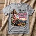 Strength and Dignity Proverbs 31:25 design on a gray T-shirt in a cozy setting