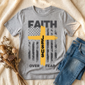 Faith Over Fear design with gold cross on a gray T-shirt in a cozy flat lay